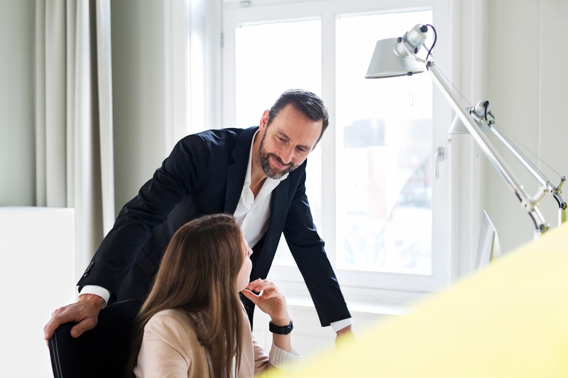 businessman-and-employee-talking-at-desk-in-office-2024-09-18-06-35-19-utc (1)